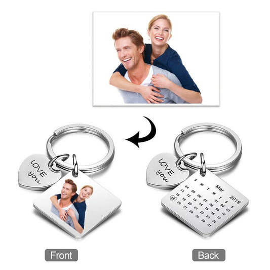 A personalized photo calendar keychain with a couple's photo printed on it, showing front and back views with 'LOVE' text and a date.