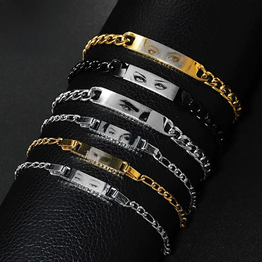 A collection of personalized laser engraved eye bracelet necklaces in silver and gold colors, displayed on a dark background.