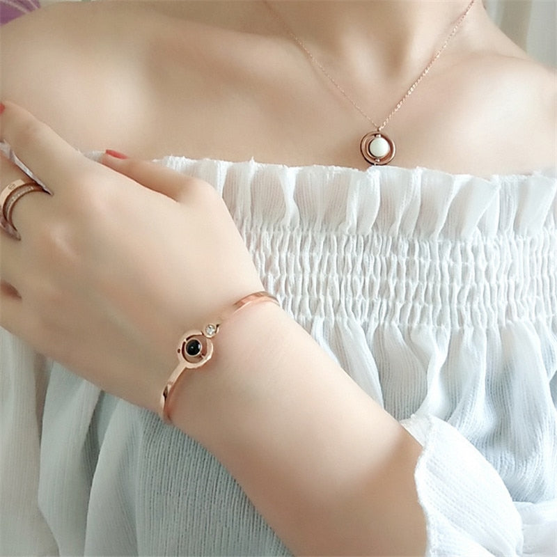 lady in white wearing 100 Languages "I Love You" Crystal Charm Bracelet
