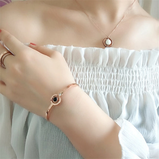lady in white wearing 100 Languages "I Love You" Crystal Charm Bracelet