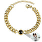 Gold chain bracelet with a black bead on a white background featuring a photo projection