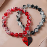 Two beaded bracelets with heart-shaped charms on a beige background