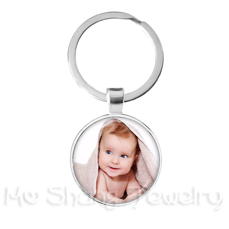 Keychain with a round pendant featuring a photo of a baby on a white background