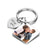 A personalized photo calendar keychain with a couple's photo printed on it, showing front and back views with 'LOVE' text and a date.