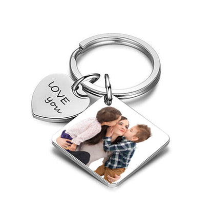 A personalized photo calendar keychain with a couple's photo printed on it, showing front and back views with 'LOVE' text and a date.