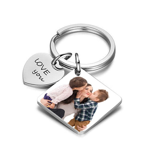 A personalized photo calendar keychain with a couple's photo printed on it, showing front and back views with 'LOVE' text and a date.
