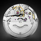 Close-up of a mechanical watch movement on a dark background