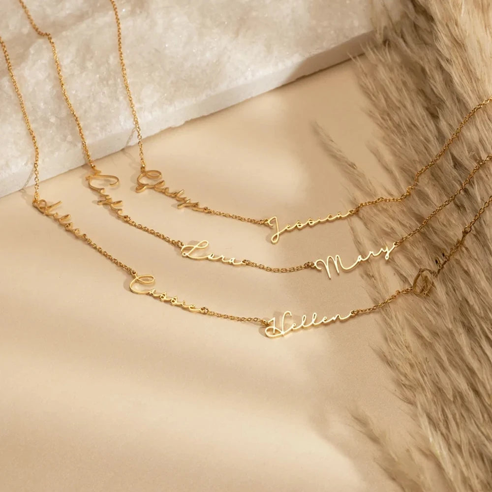 Gold name necklaces on a soft surface