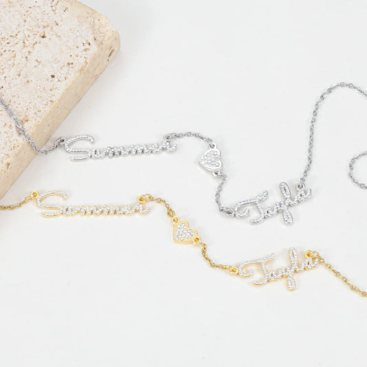 Two gold and silver necklaces with name inscriptions on a light background