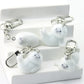 Set of marble-textured keychains with silver hooks on a white box