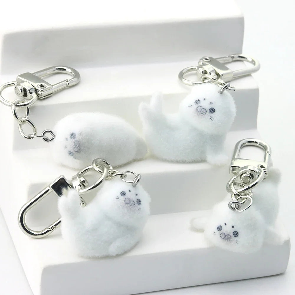 Set of marble-textured keychains with silver hooks on a white box