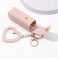 Pink heart-shaped keychain with gold accents on a white background