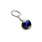 Keychain with a dark glass sphere featuring a colorful nebula design on a white background