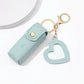 Light blue keychain case with a heart-shaped keychain on a white background