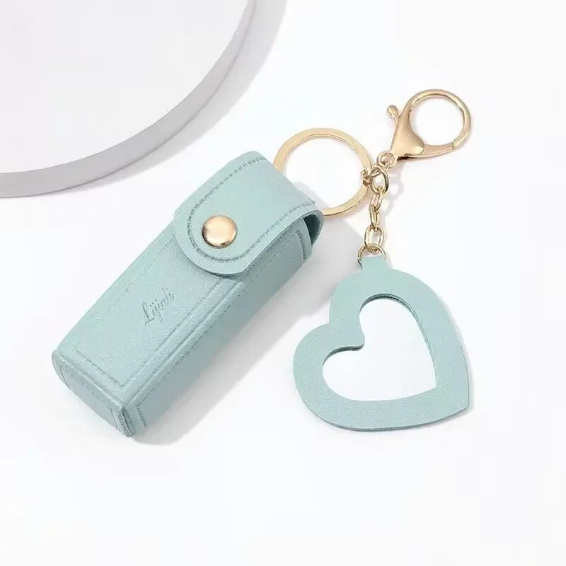 Light blue keychain case with a heart-shaped keychain on a white background