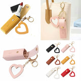 Collage of heart-shaped keychains in various colors with a beige handbag in the background.