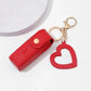 Red keychain case with a heart-shaped keychain on a white background