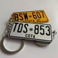 Two license plate keychains on a white background