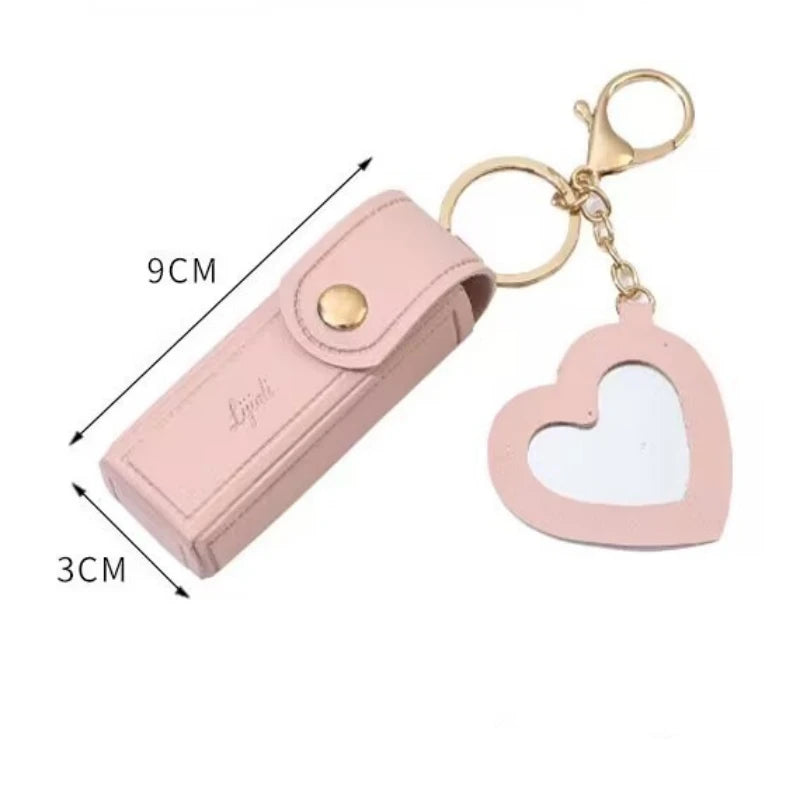 Pink keychain with heart design and measurements on a white background