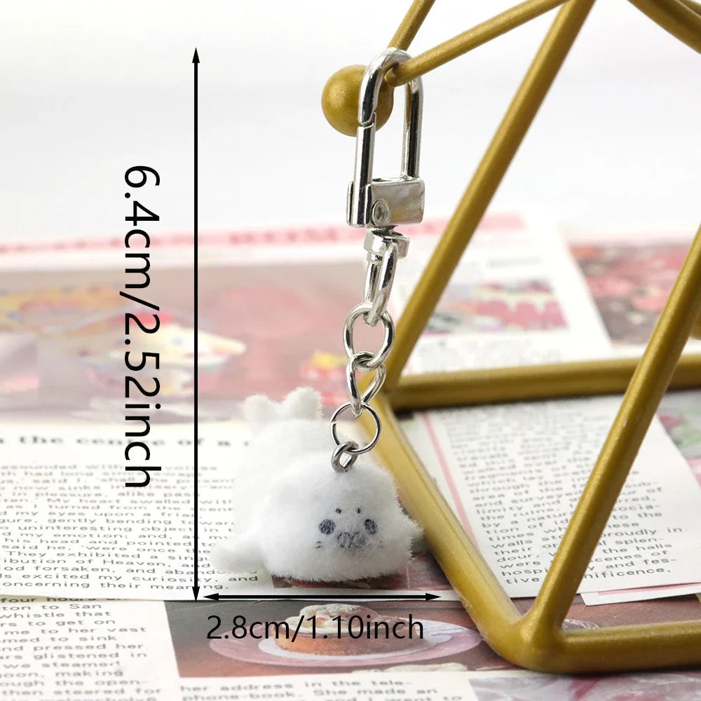 Small plush keychain with measurements on a blurred background