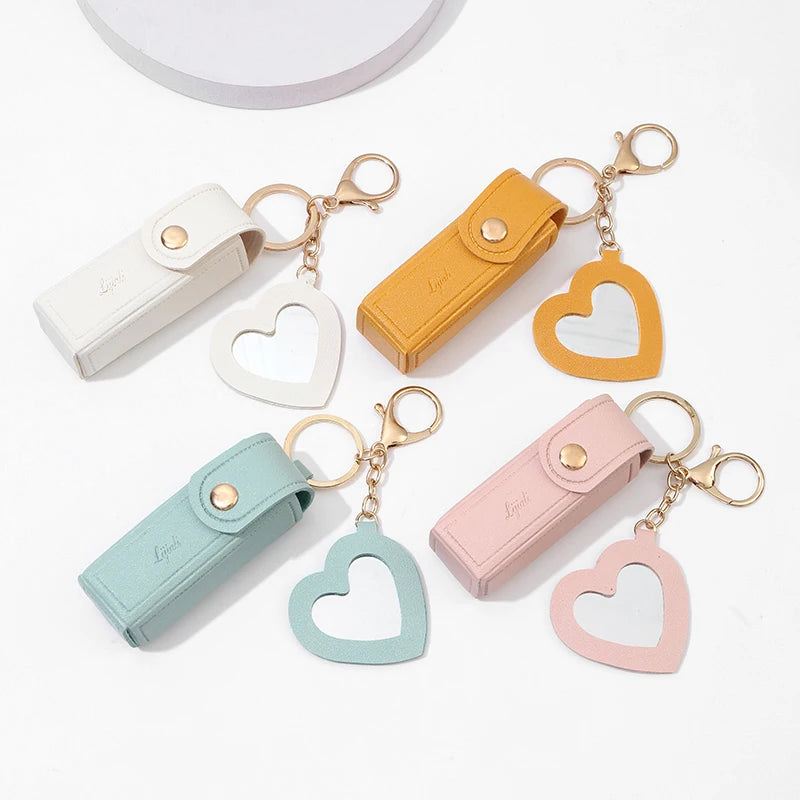 Set of colorful keychains with heart-shaped designs on a white background