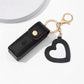 Black keychain case with a heart-shaped keychain on a white background