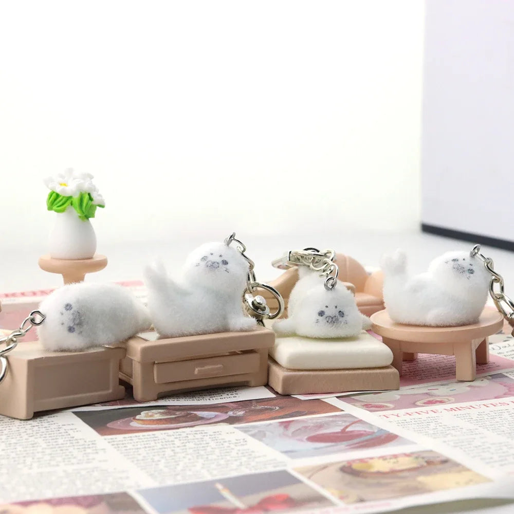 Set of small white cat figurines on stands with a plain background
