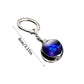Keychain with a blue glowing stone on a white background
