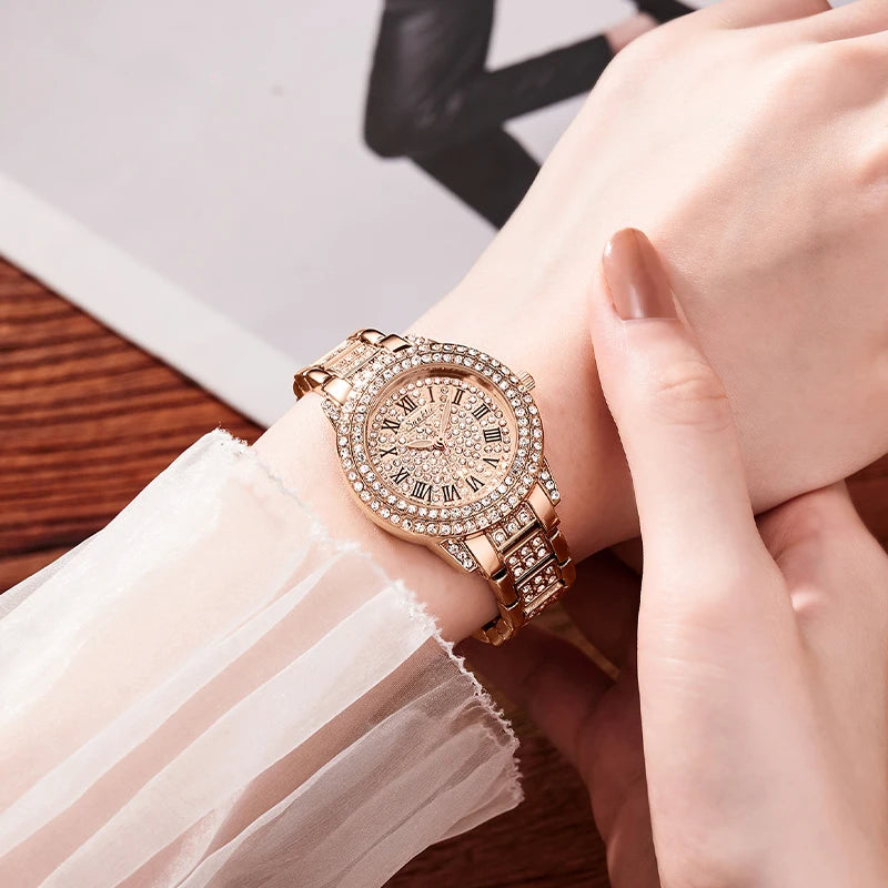 Rose gold watch with diamond accents on a wrist, blurred background