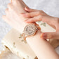 Rose gold wristwatch with diamond accents on a wrist, against a soft background.