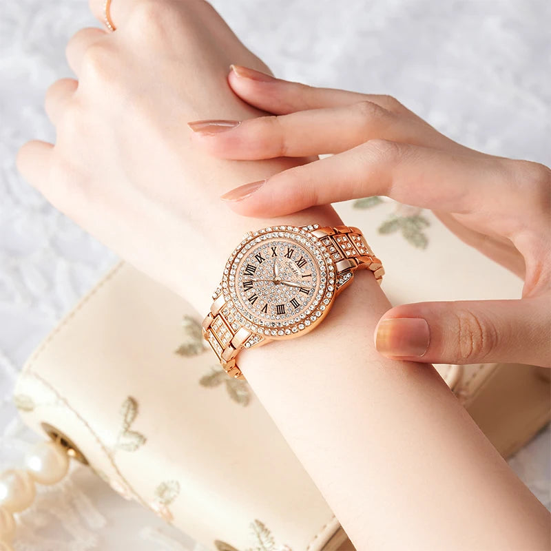 Rose gold wristwatch with diamond accents on a wrist, against a soft background.